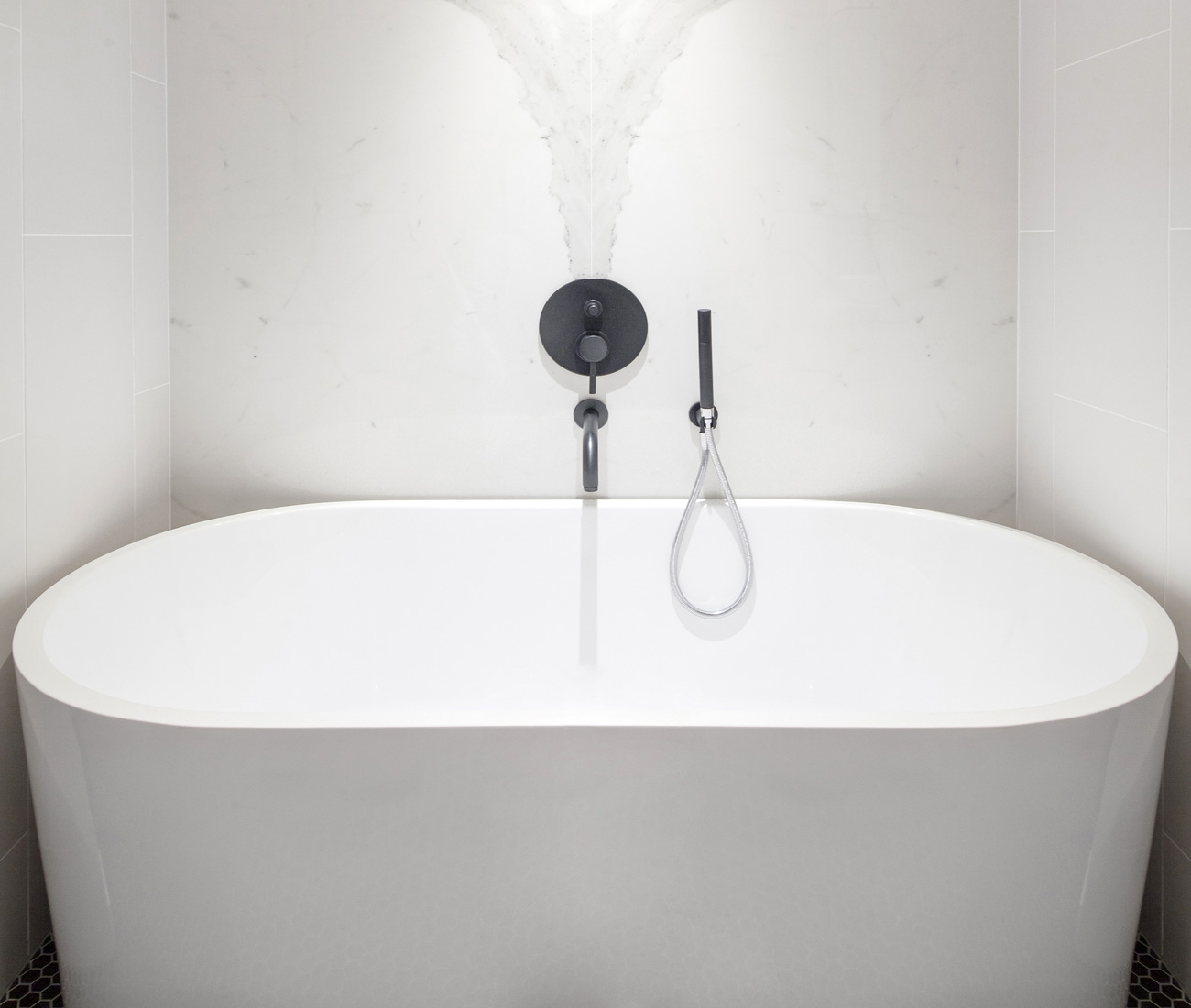 freestanding tub and hex-mosaic floor tiling