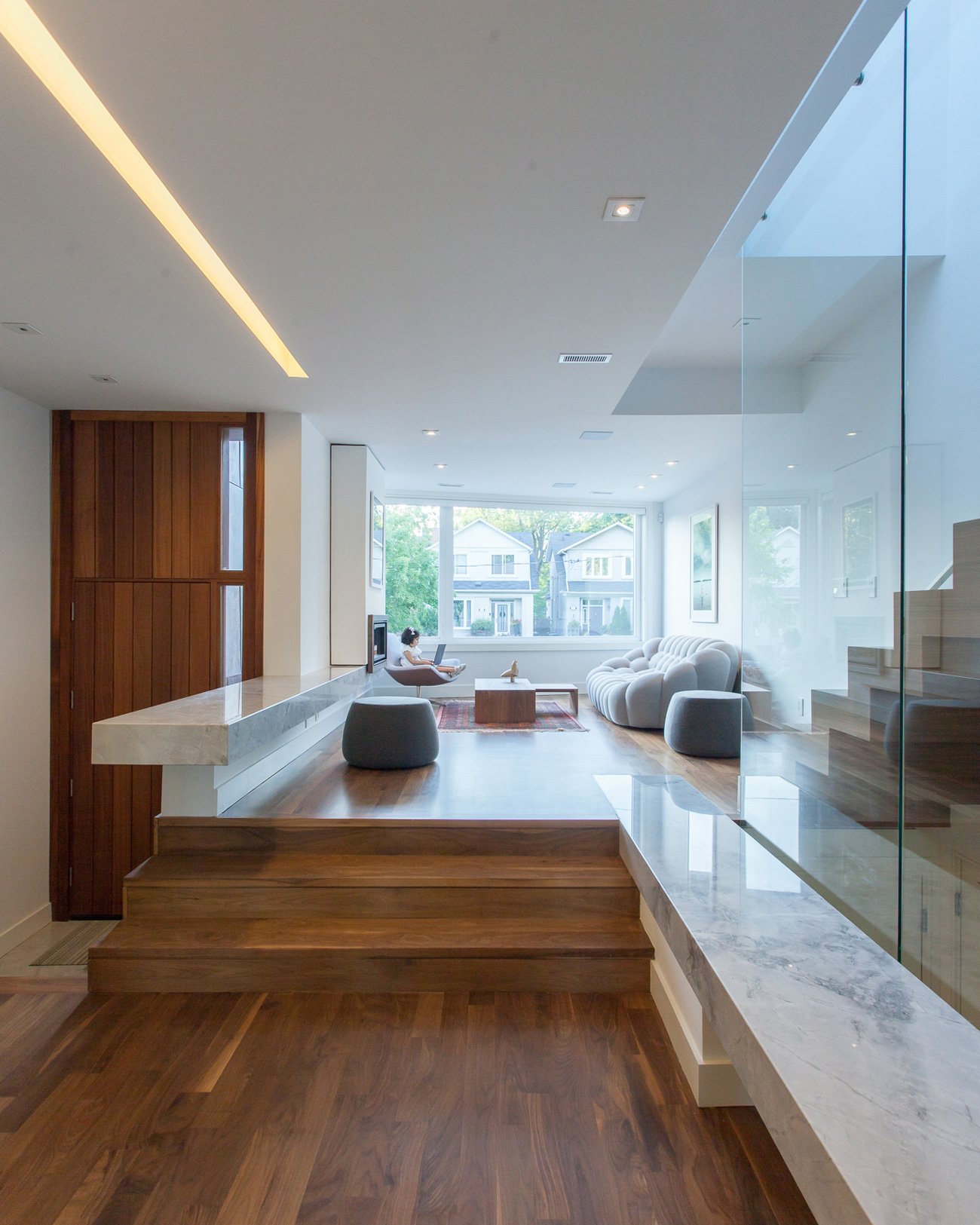 Interior of a narrow lot home showcasing a spacious living room with open flow