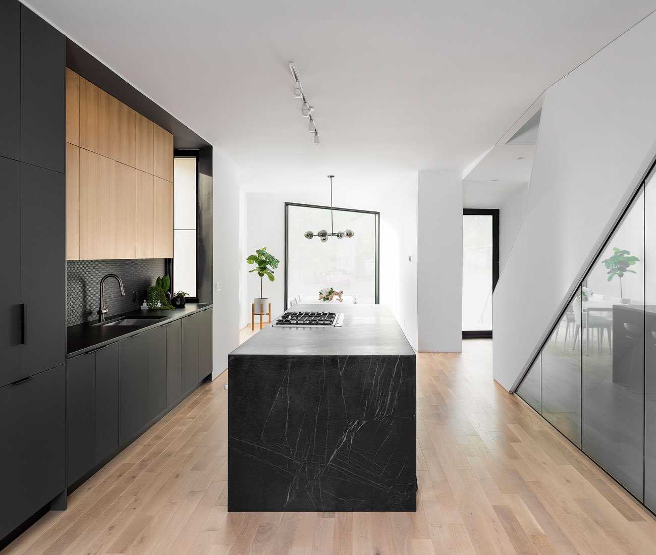 Custom kitchen with rift oak cabinets, 3.7-metre soapstone island, and solid white oak flooring. Phaedrus Studio Tesseract House