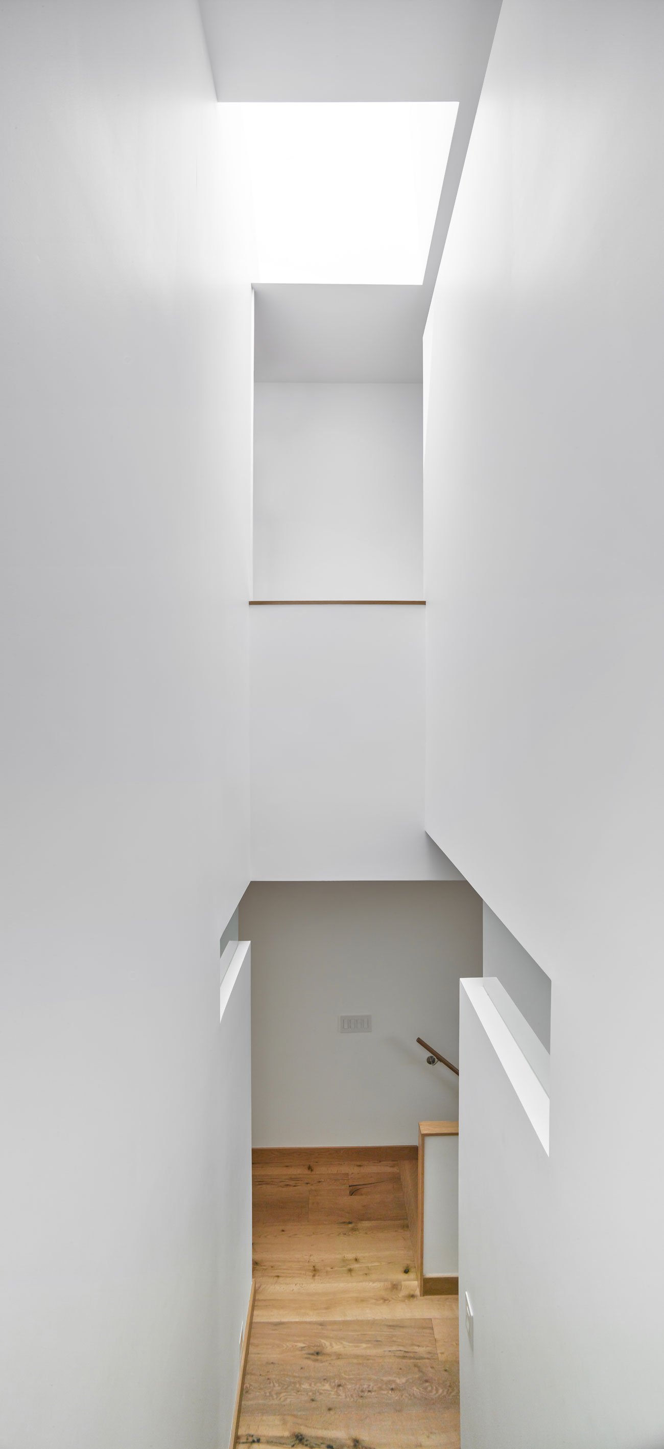 Stairs view with a skylight at a Leslieville semi by Brian O’Brian Architect